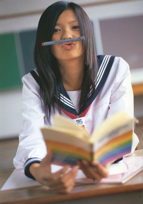 Playful asian babe flirts and intices in her yellow bikini