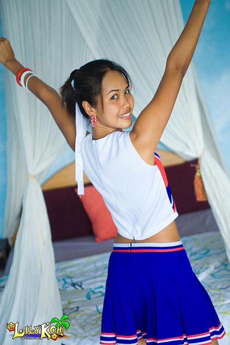 Delicate Asian teen cheerleader flashes cotton panties
