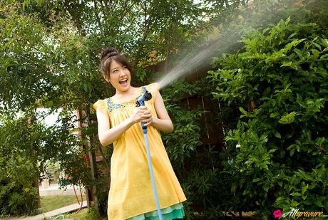 Saki Fukuda Asian in cute yellow dress tries to keep garden wet