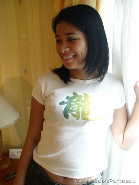 Amateur Asian girl with tiny tits strips and toys her pussy on the bed