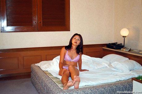 Stunning Asian wife with small tits and a sexy booty strips and reveals her naked form