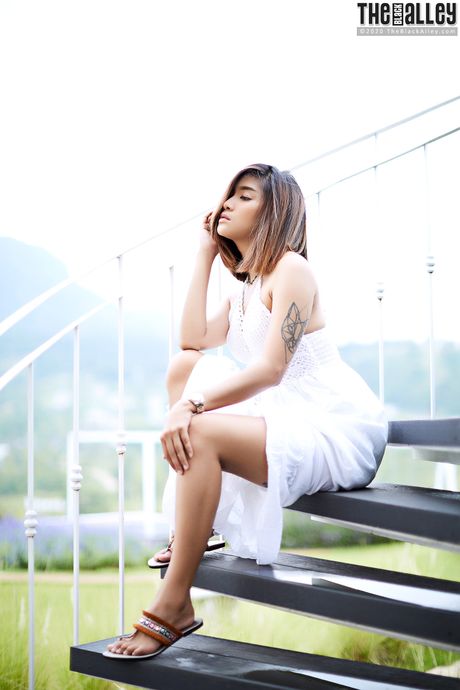 The Asian babe Apple strips and shows her hairy pussy in a solo outdoors